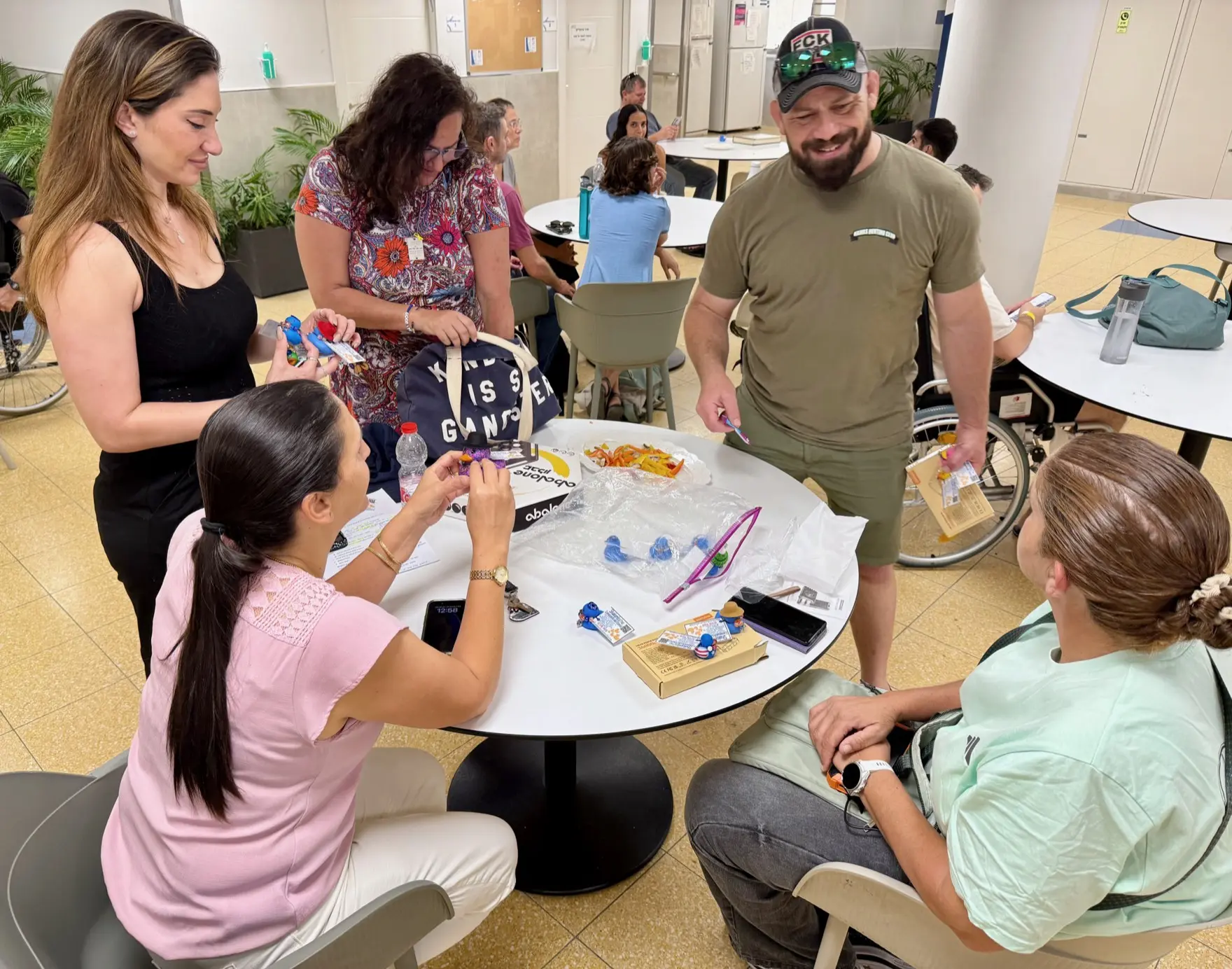 Atlanta Israel Coalition volunteers and participants gather around a table during a hands-on program.